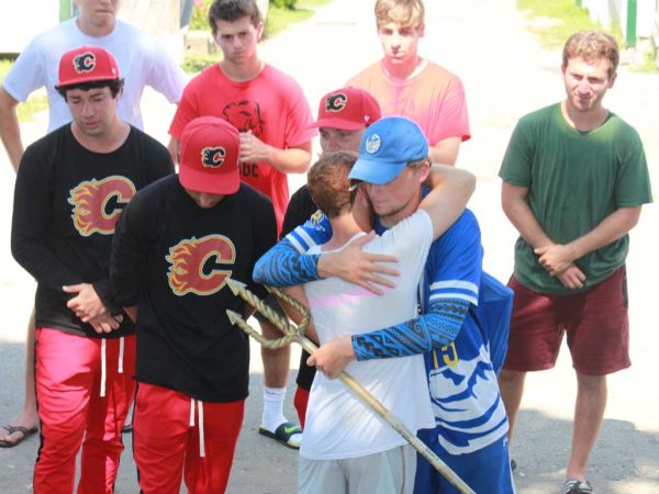 Teen boys at Bauercrest embracing after competition