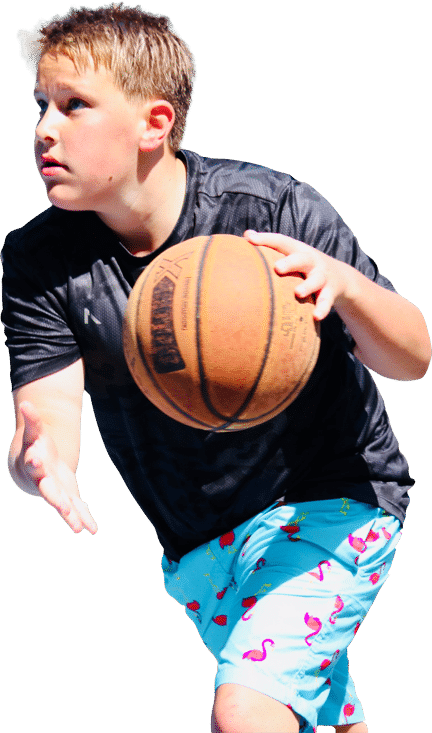 Young teen camper playing basketball