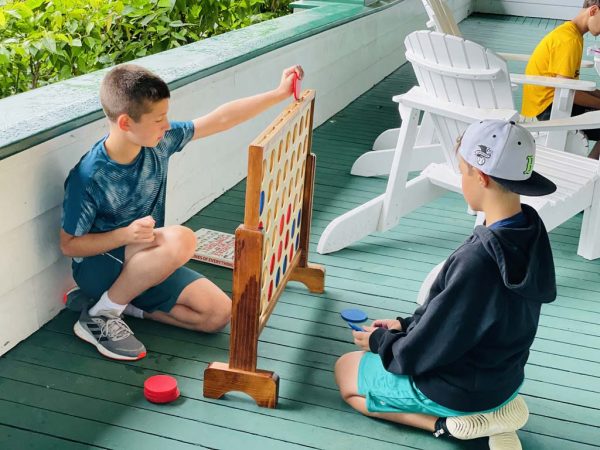 Two campers play a large version of connect four